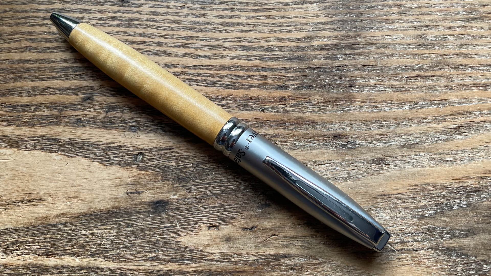 The photo is of a pen, symbol of writing