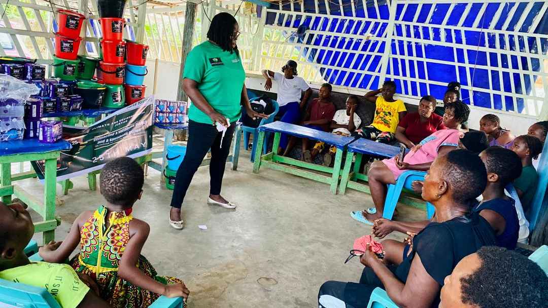 Community women receiving training on how to use menstrual kits, and menstrual kits that have been brought to be donated to them