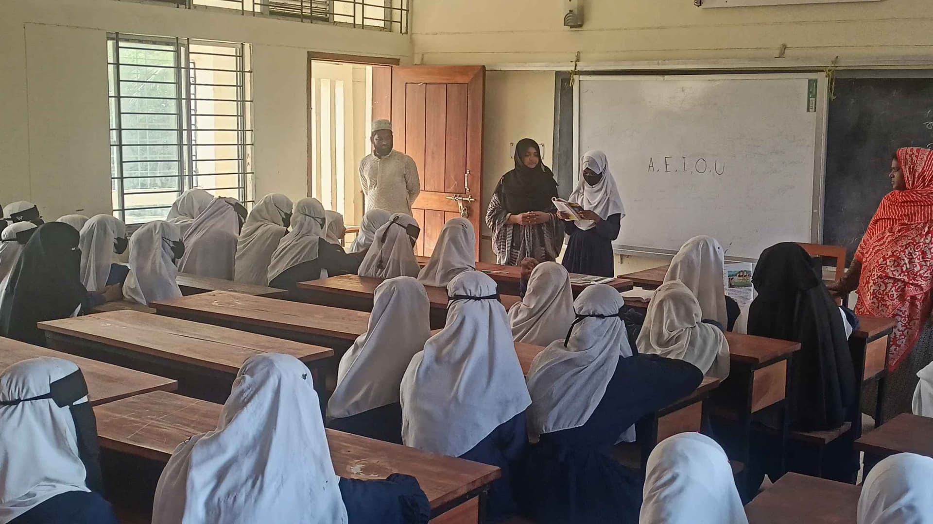 This is a picture of our Thursday special class where i am helping girls from all classes to improve their English reading and pronunciation skill.
