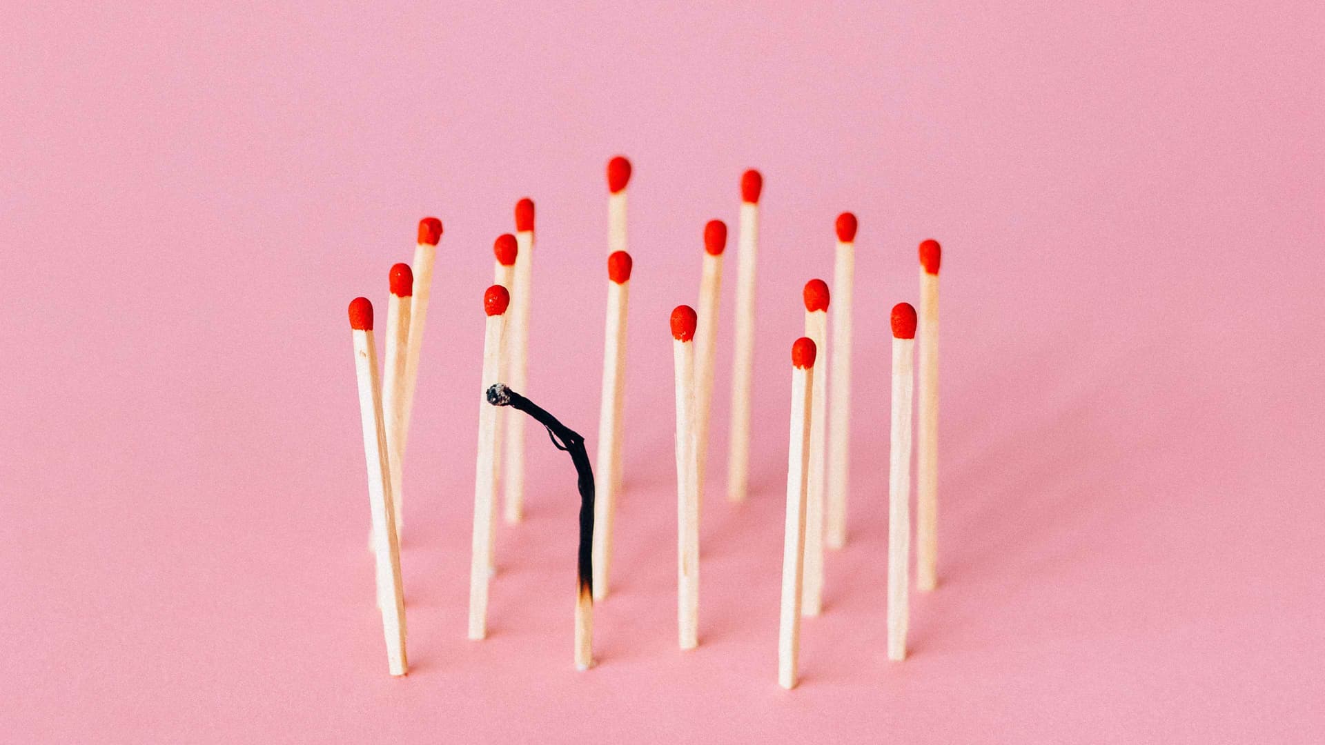 Photo of a group of unlit matches - one of them is burnt-out
