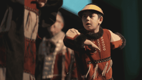 Unangax boy dancing in traditional regalia