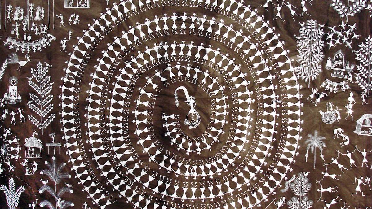A painting of a community dancing in a spiral in a Warli village, created with flour paste on a mud surface.