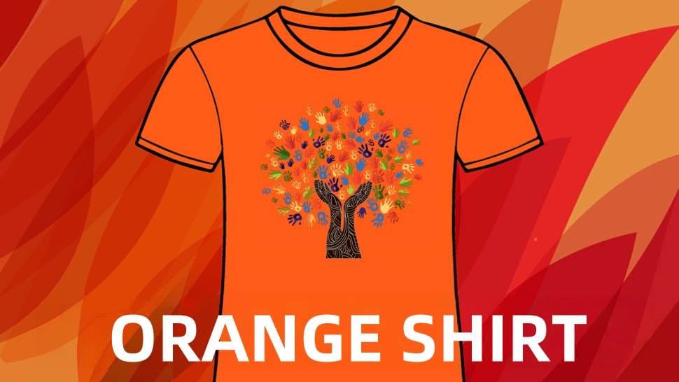 A photo of one of the Orange Shirt T-shirt designs. As the trunk of the tree arms reach up with hands holding the leaves, many hands of children