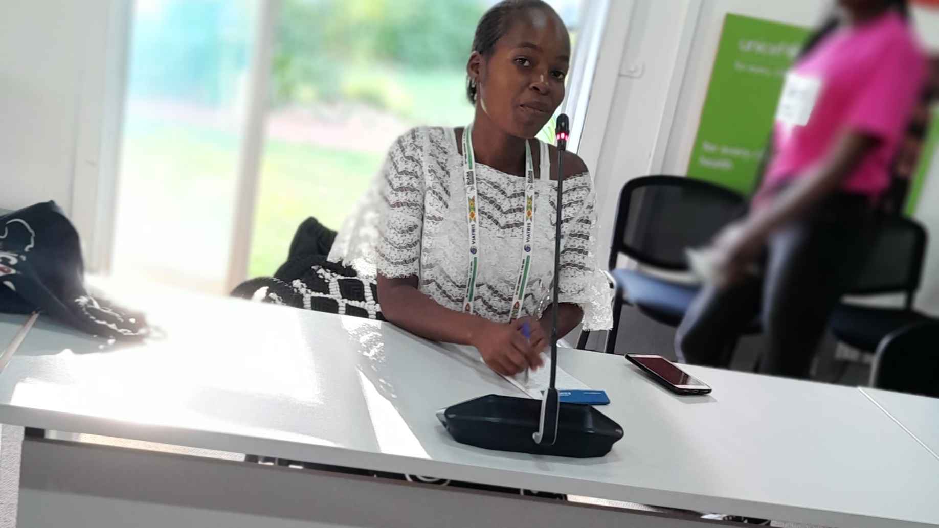 I am seated, with a wireless microphone while speaking during a UNICEF event. I appear confident and engaged as I share my journey—a moment that reflects the power of youth voices and the digital opportunities that made it possible.
